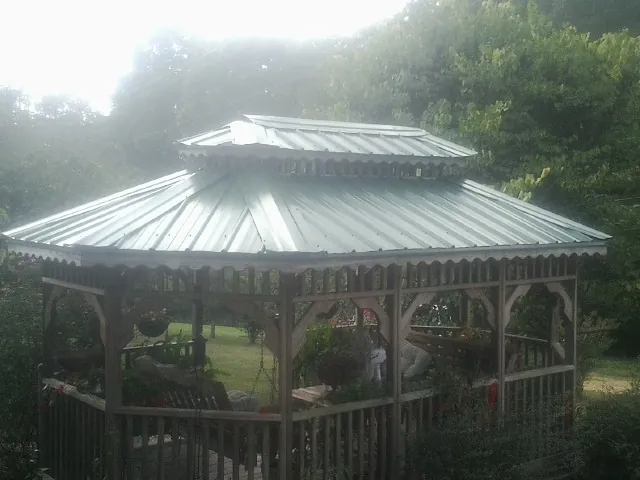 Two tier green metal roof on a garden gazebo in Falls Of Rough