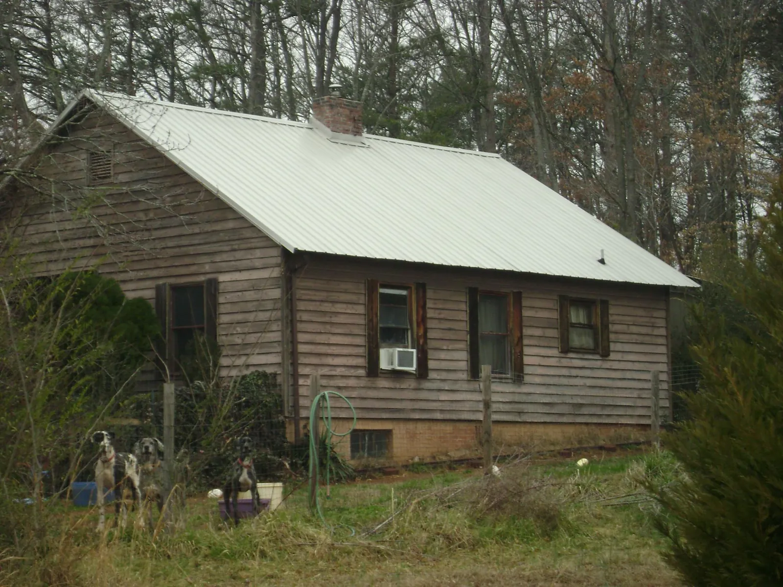 White metal roof on an old wood sided farmhouse, from a Metal Roof Installation job in Falls Of Rough